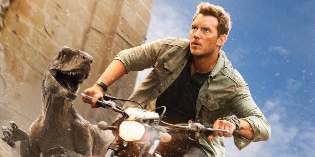 Chris Pratt with an atrociraptor in Jurassic World Dominion