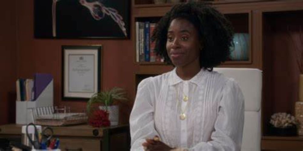 Kirby Howell-Baptiste as Simone in The Good Place wearing a white shirt, sat at a desk