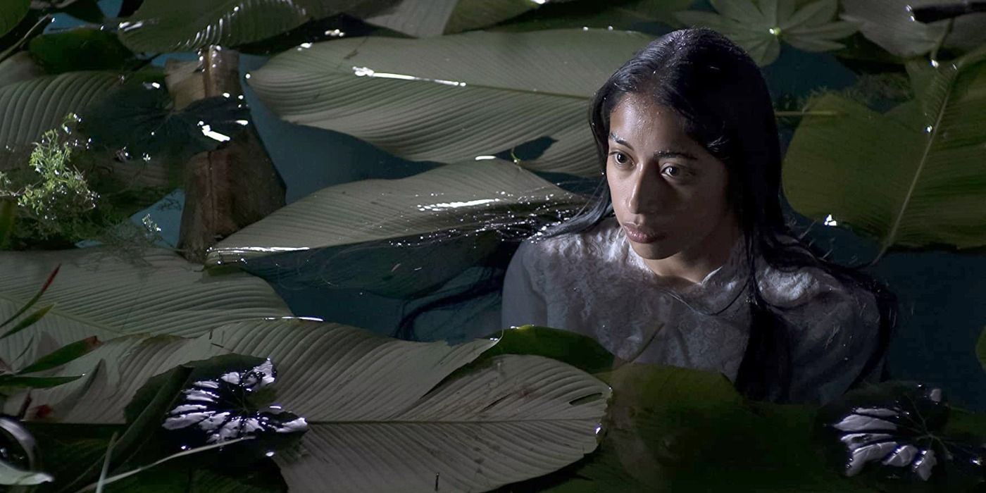 Maria Mercedes Coroy as Alma in the water surrounded by lilypads in La Lllorona