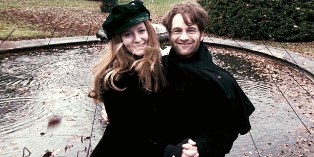 Lily Evans and James Potter from Harry Potter in winter clothing dancing and smiling at the camera