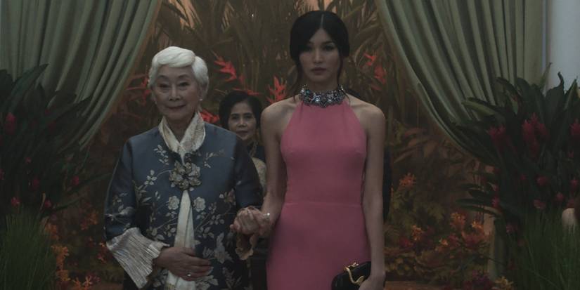 Astrid (Gemma Chan) walks down the aisle with Ah Ma (Lisa Lu) in Crazy Rich Asians