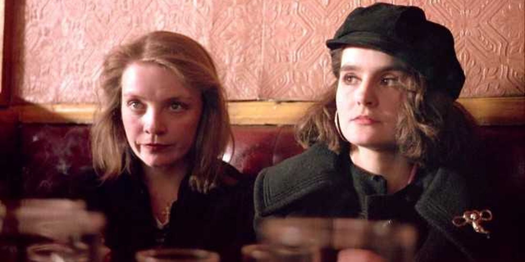 Lizzy and Gail sitting side by side at a pub table in Trainspotting.