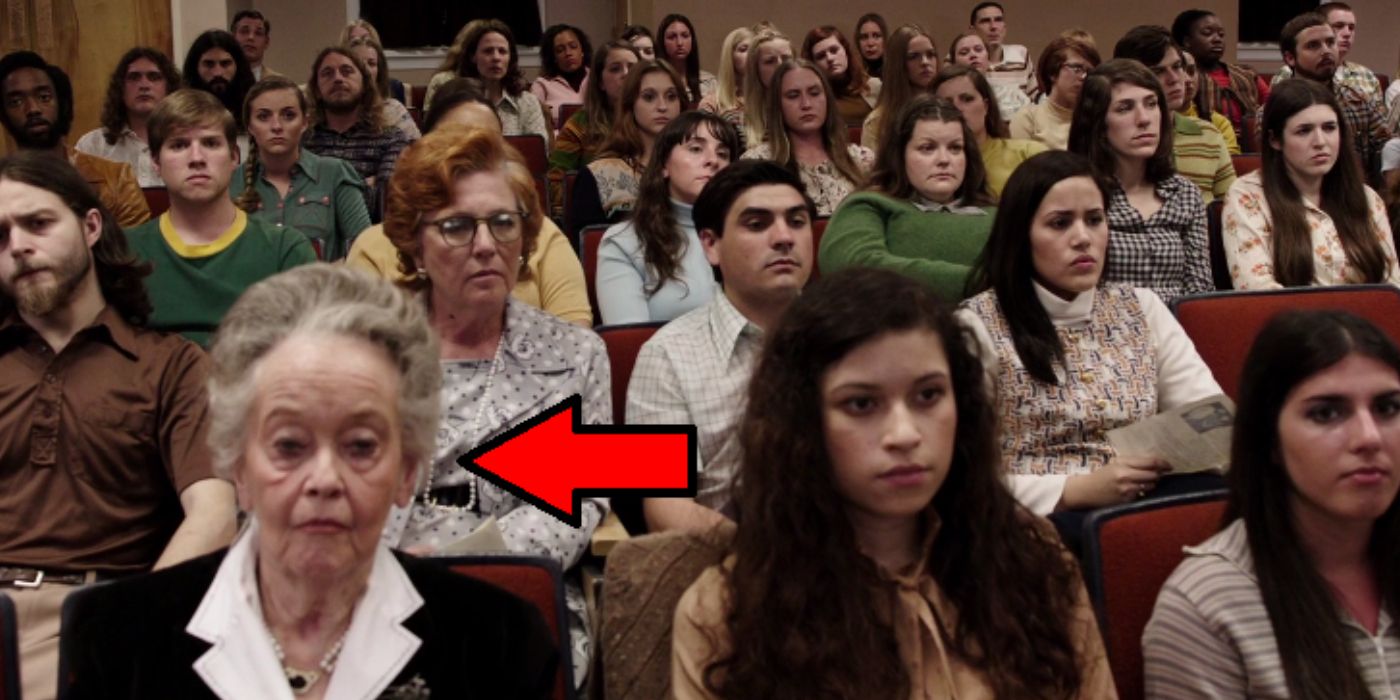 Lorraine Warren sitting amongst an audience witnessing a talk on exorcism in The Conjuring