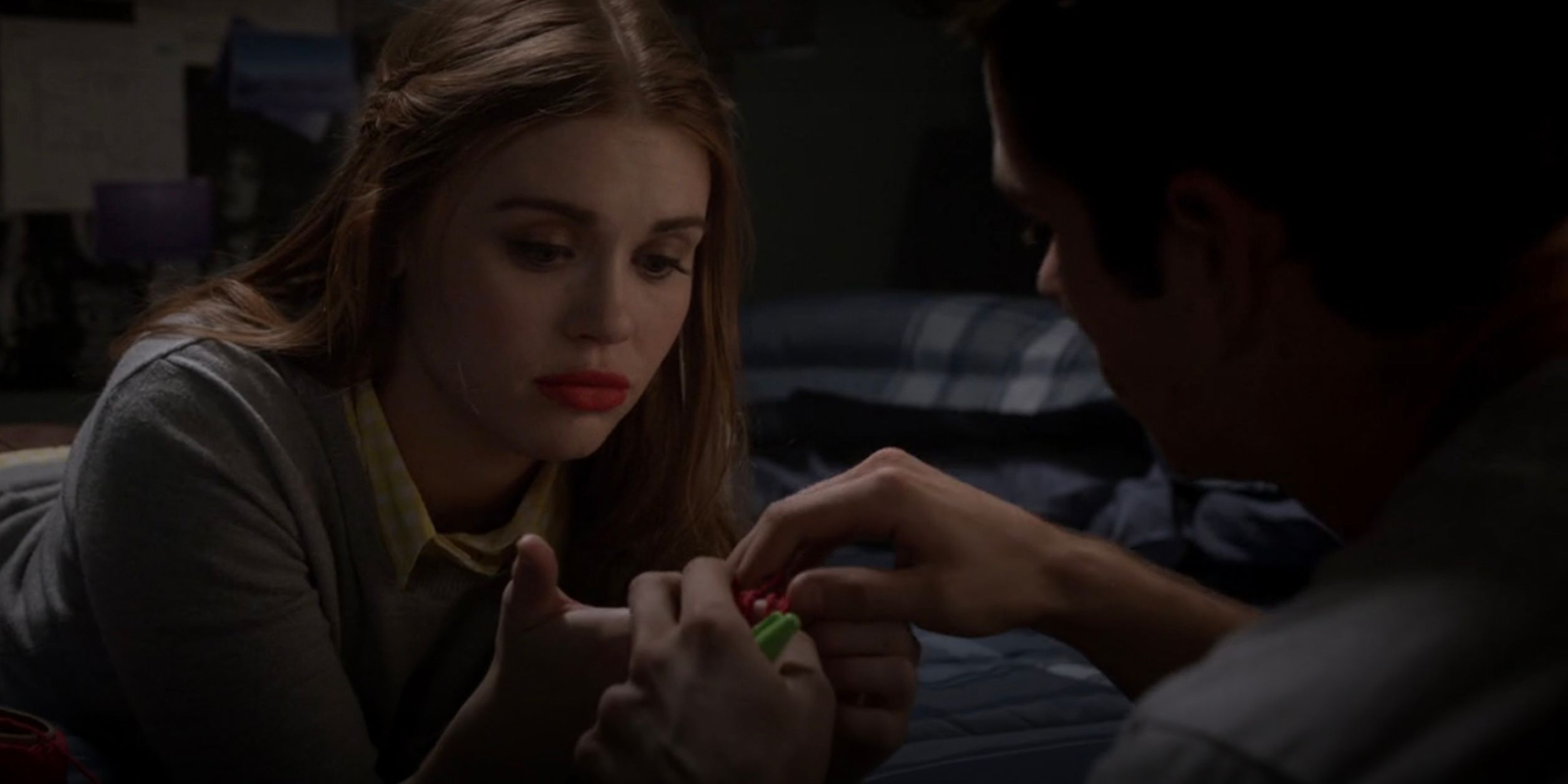 Lydia sits on Stiles' bed in Teen Wolf.