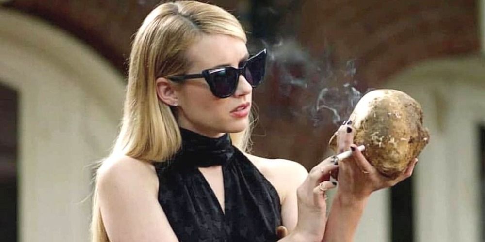 Madison Montgomery holding a skull and a cigarette in a scene from AHS Apocalypse