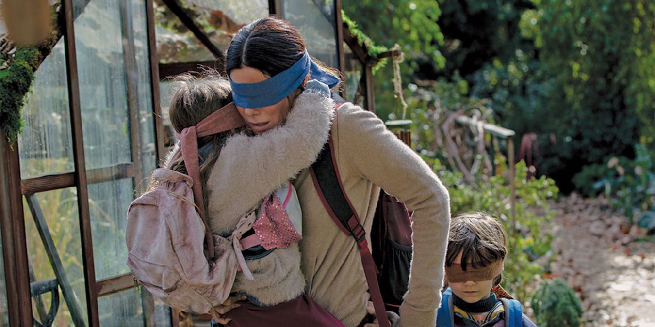 Malorie walking down a path with the kids, all wearing blindfolds in Bird Box