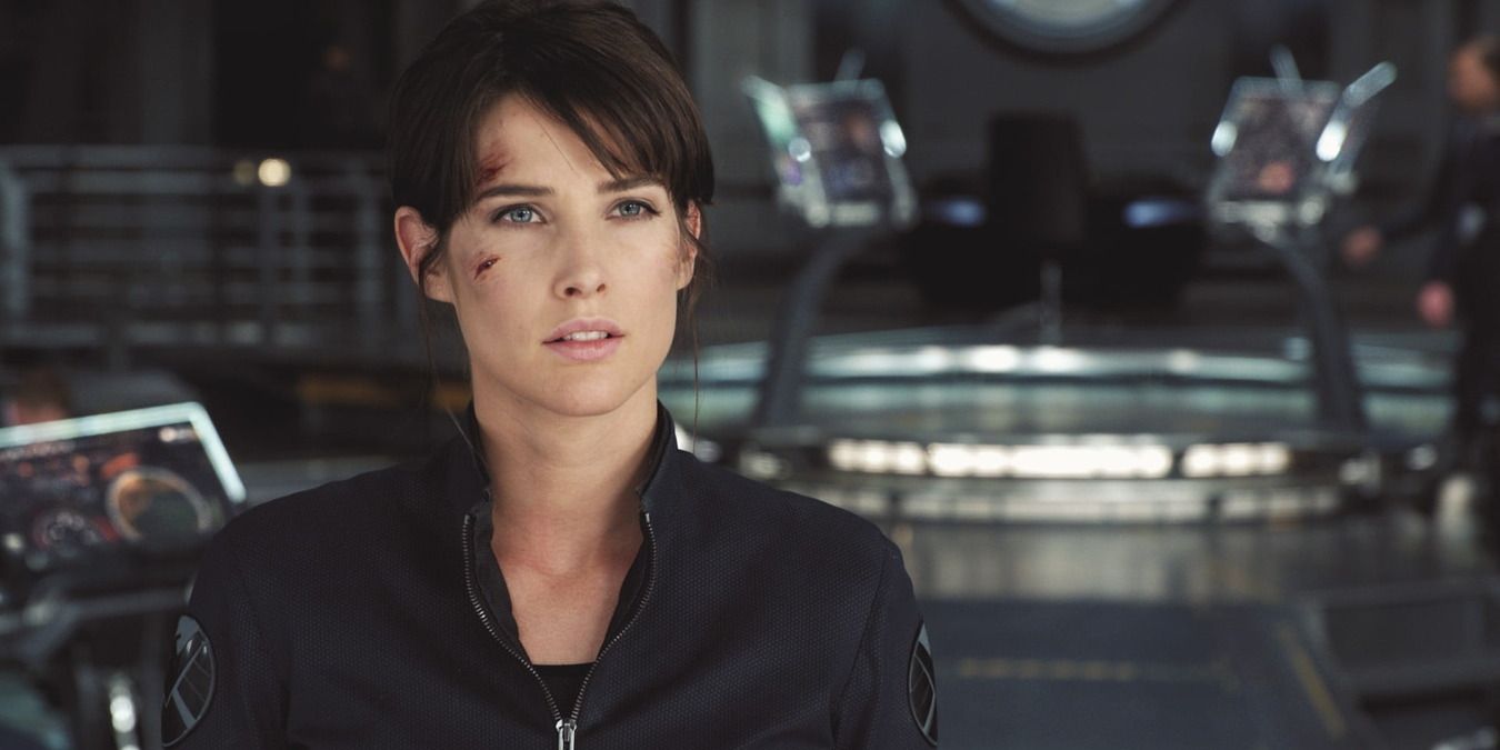 Maria Hill standing in the computer room, wearing her uniform and a scar on her cheek
