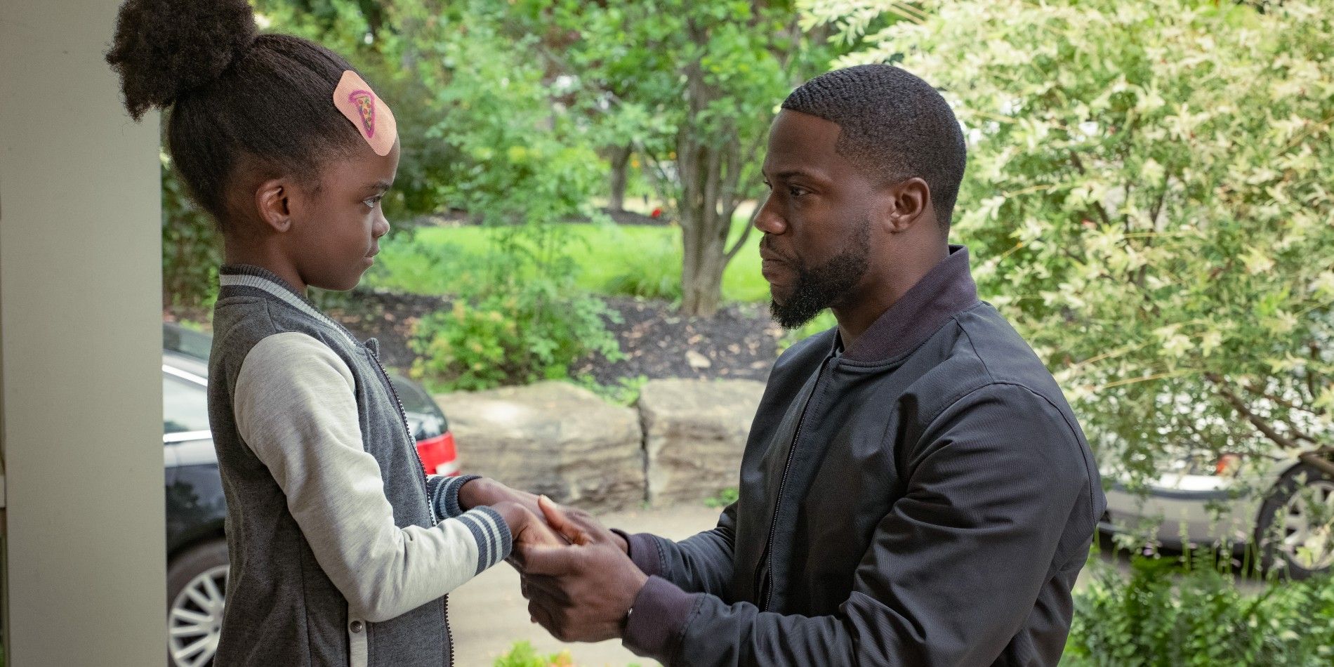 Melody Hurd and Kevin Hart facing each other in Fatherhood