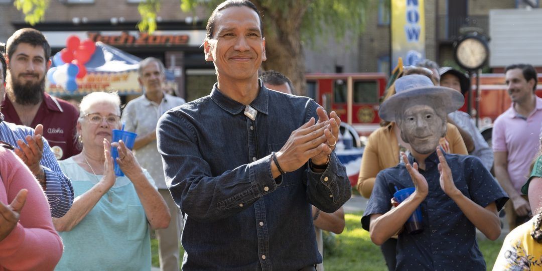 Terry claps at a town gathering