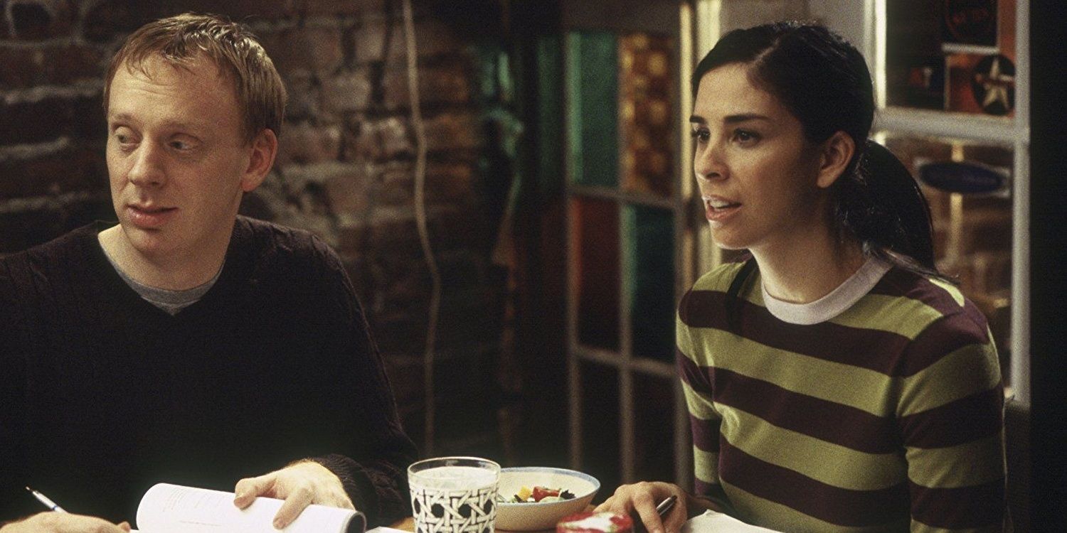 Mike White writing on a book sitting next to Sarah Silverman in a still from School of Rock