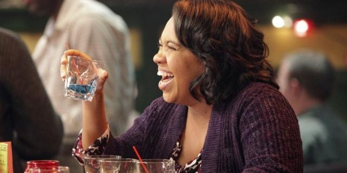 Miranda laughing while drining at a bar