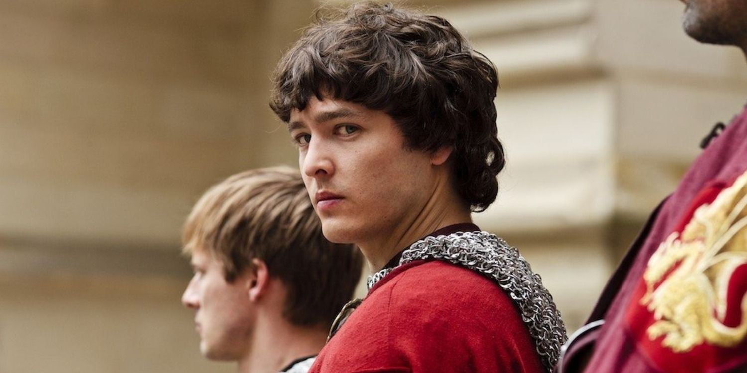 Mordred standing on the steps of the castle with the other knights in Merlin