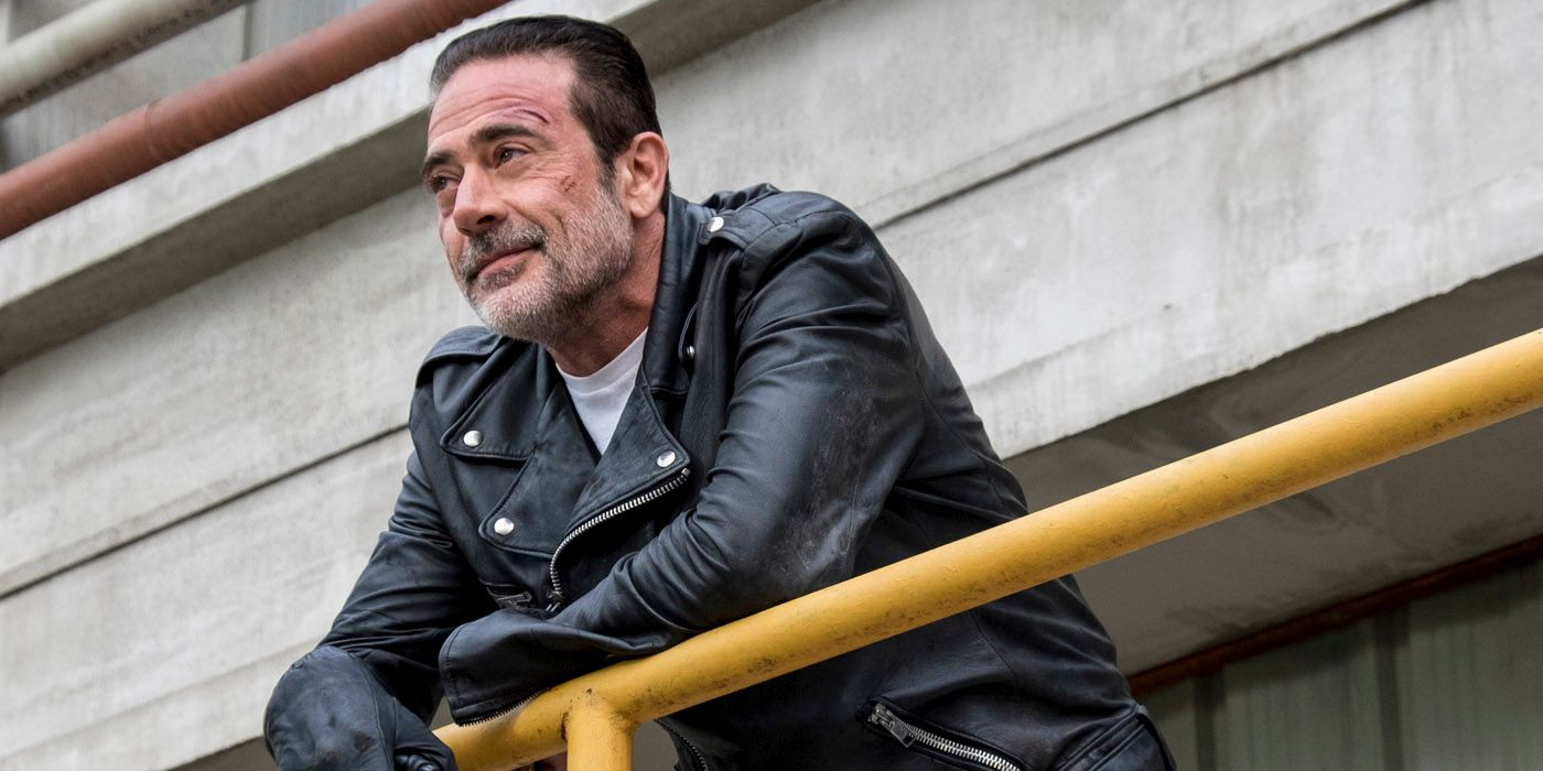 Negan leaning on a banister in TWD.