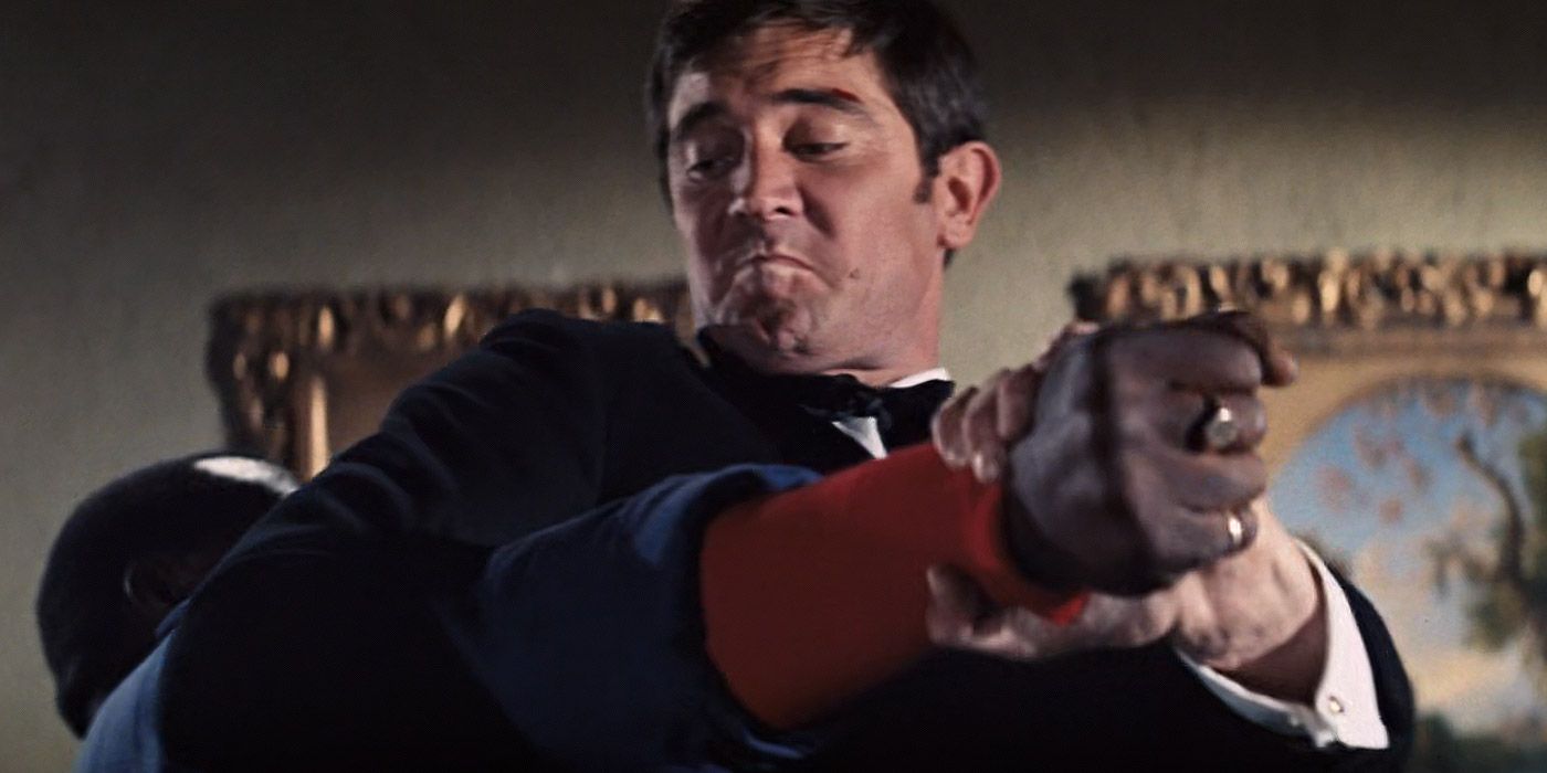 Bond fights a henchman inside Tracy's hotel room