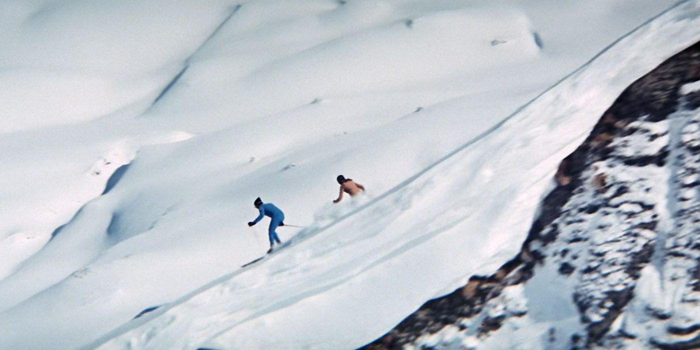 Bond and Tracy ski down a hill to escape Blofeld and his men