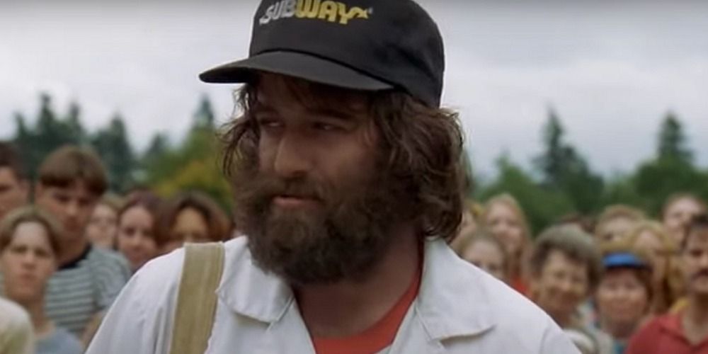 Otto wearing a Subway hat in front of a crowd in Happy Gilmore