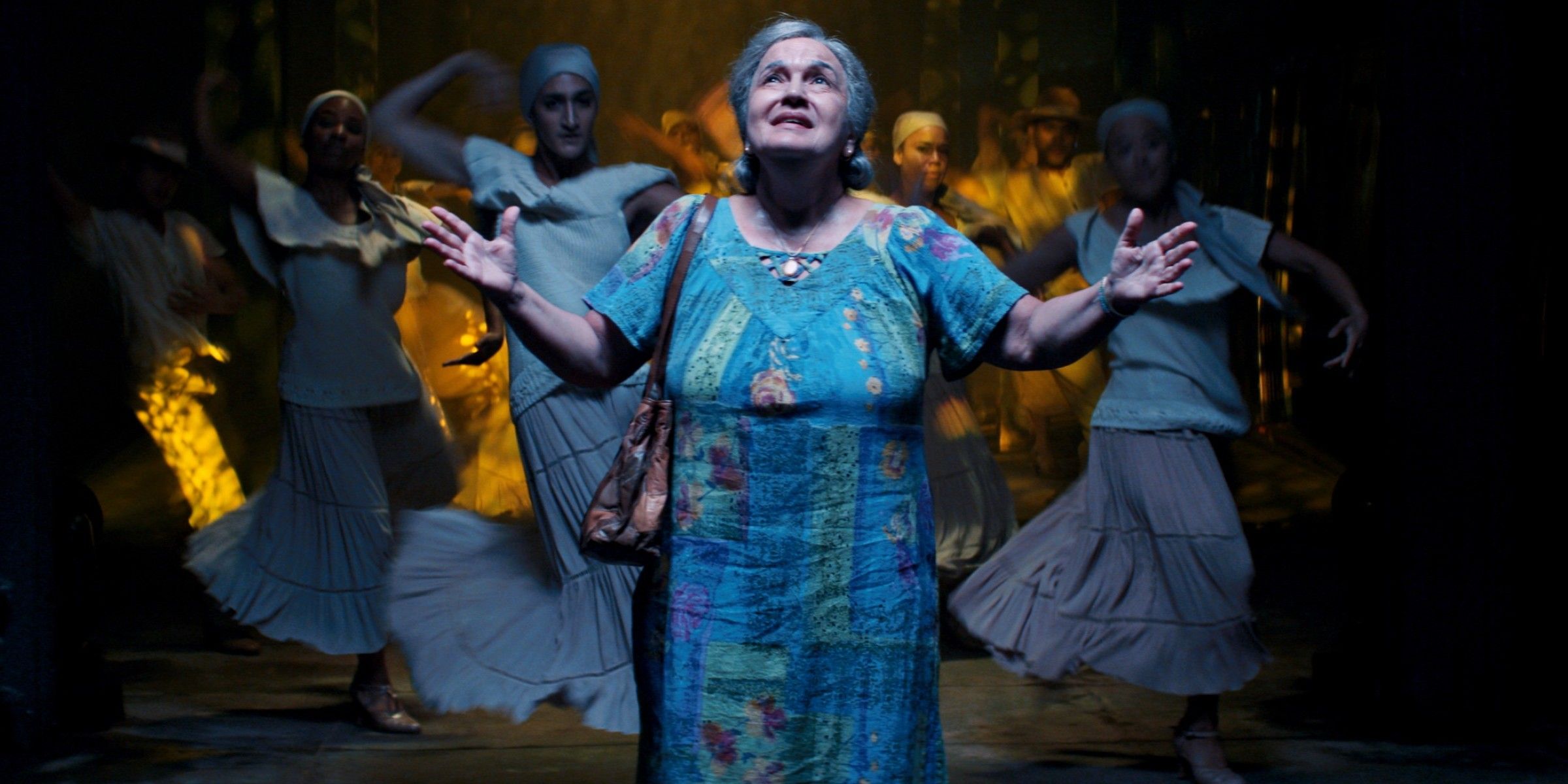 Abuela looks back on her life in In The Heights as she holds her hands out