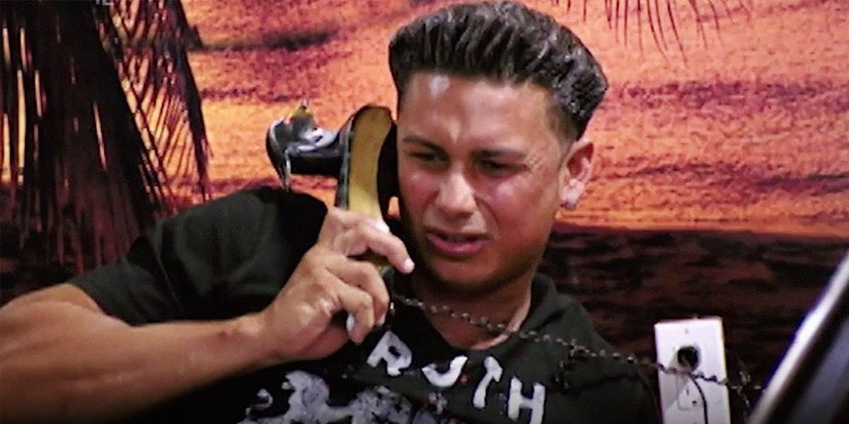 Pauly D makes a disgusted face while talking on the phone.