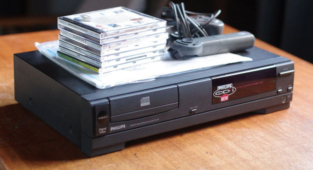 The Phillips CD-i video game console, along with controllers and a stack of games.