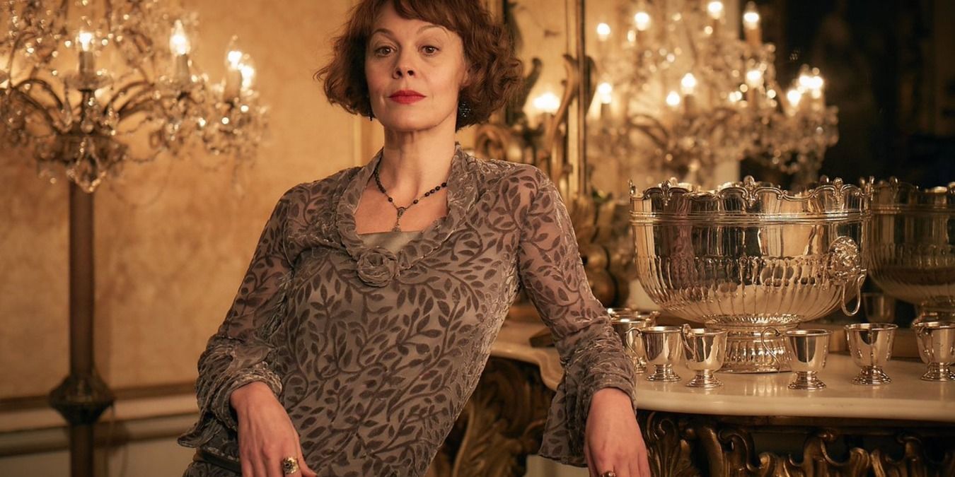 Polly Gray leaning against a table in Peaky Blinders
