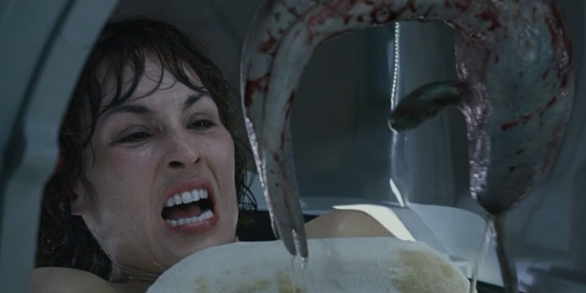 A mechanized claw removes an alien fetus from Shaw's abdomen in Prometheus.