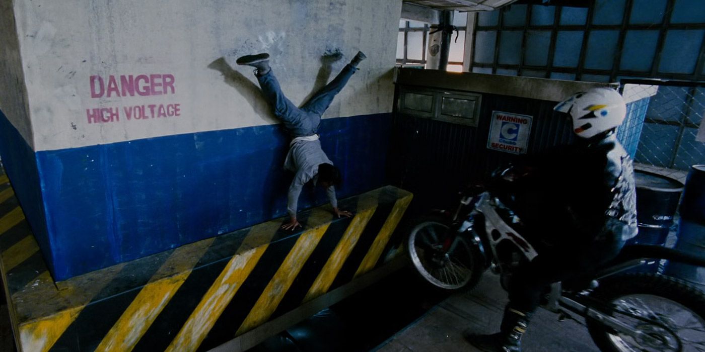 Kham does a backflip hand stand to avoid being run over