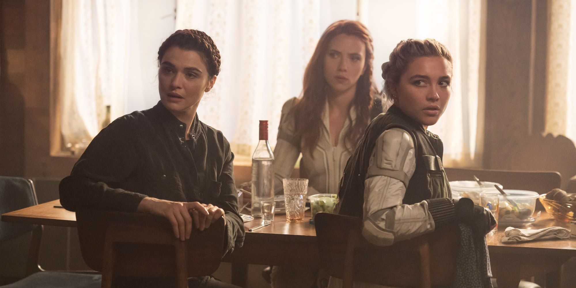 Natasha, Yelena and Melina sit at table in Black Widow