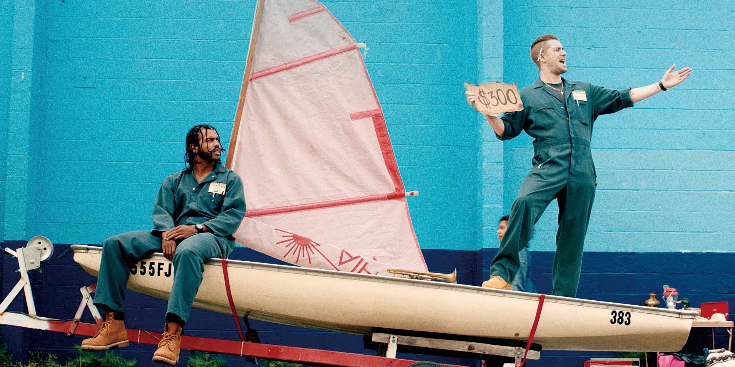 Rafael Casal standing and Daveed Diggs sitting on a mini yacht in Blindspotting