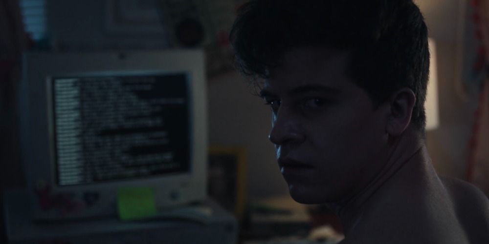 Derek sitting at his computer in the dark in Cruel Summer