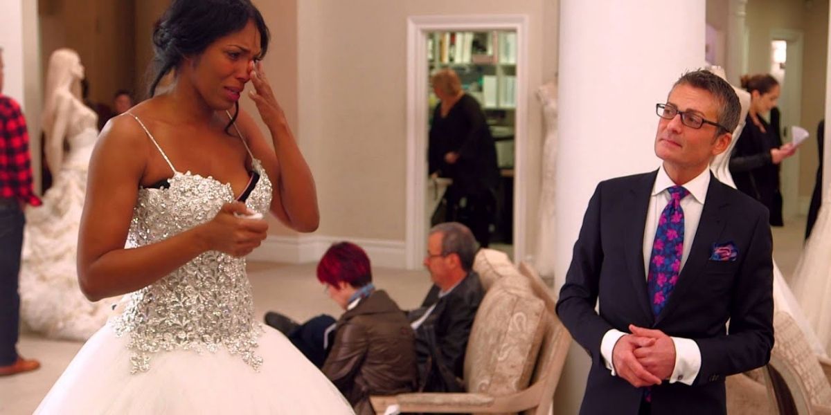 A bride cries when she sees herself in her wedding dress