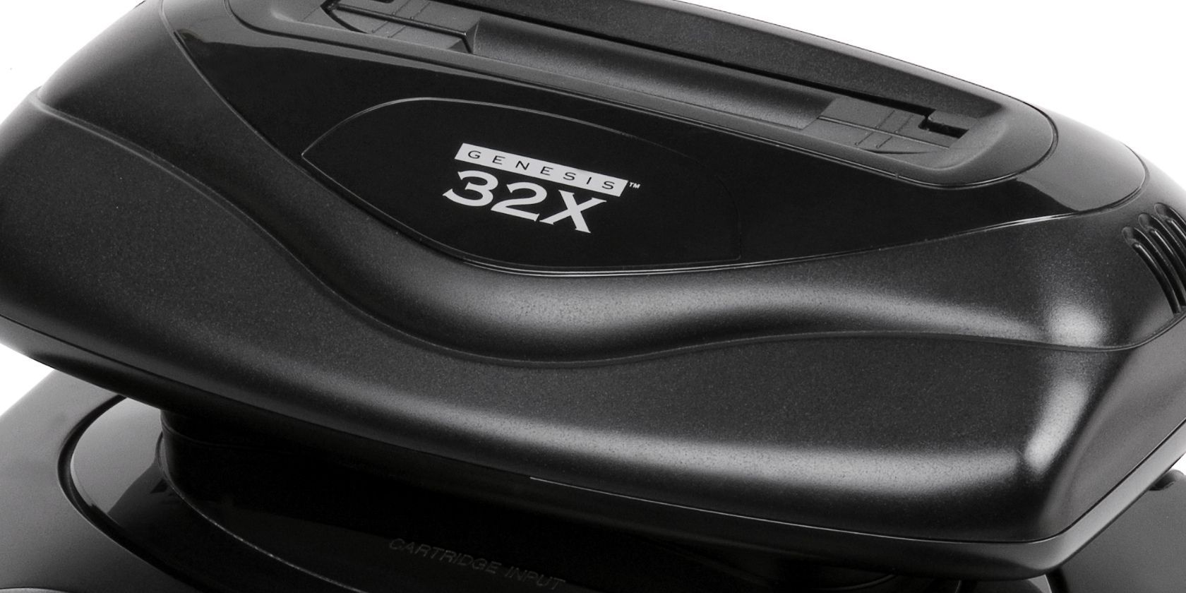 A close-up of the Sega 32X video game console add-on.
