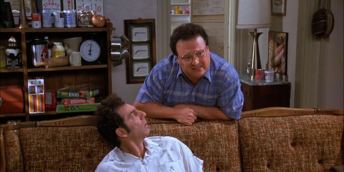 Kramer and Newman talking by a couch on Seinfeld