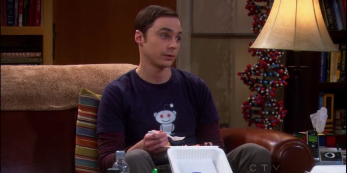Sheldon eating take out while wearing his Reddit T-shirt in The Big Bang Theory.