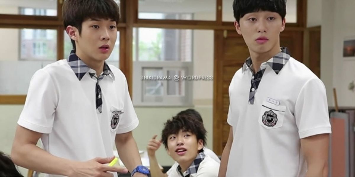Three school kids looking at something with surprised expressions