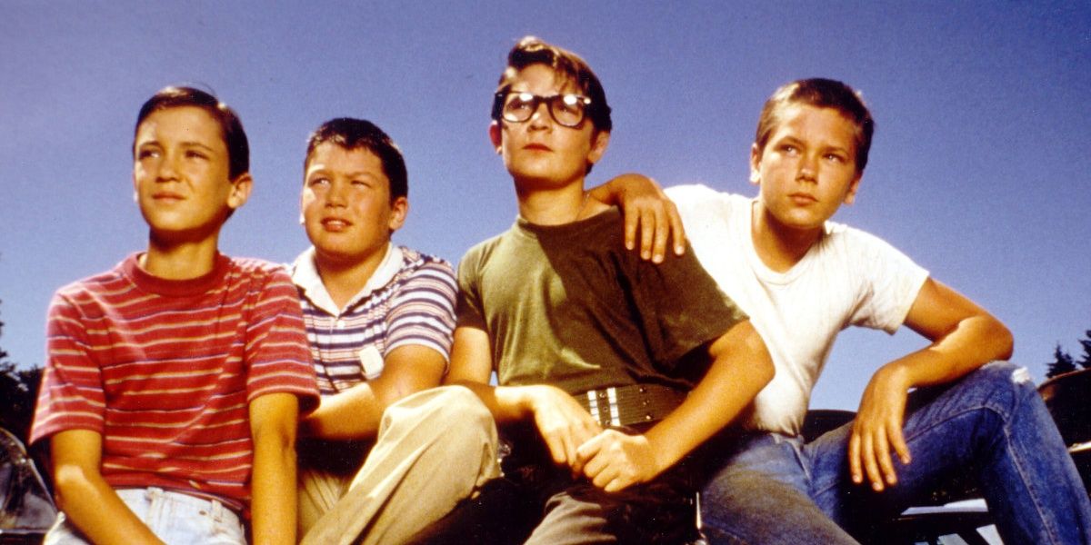 Four kids look on with the sky in the background from Stand by Me