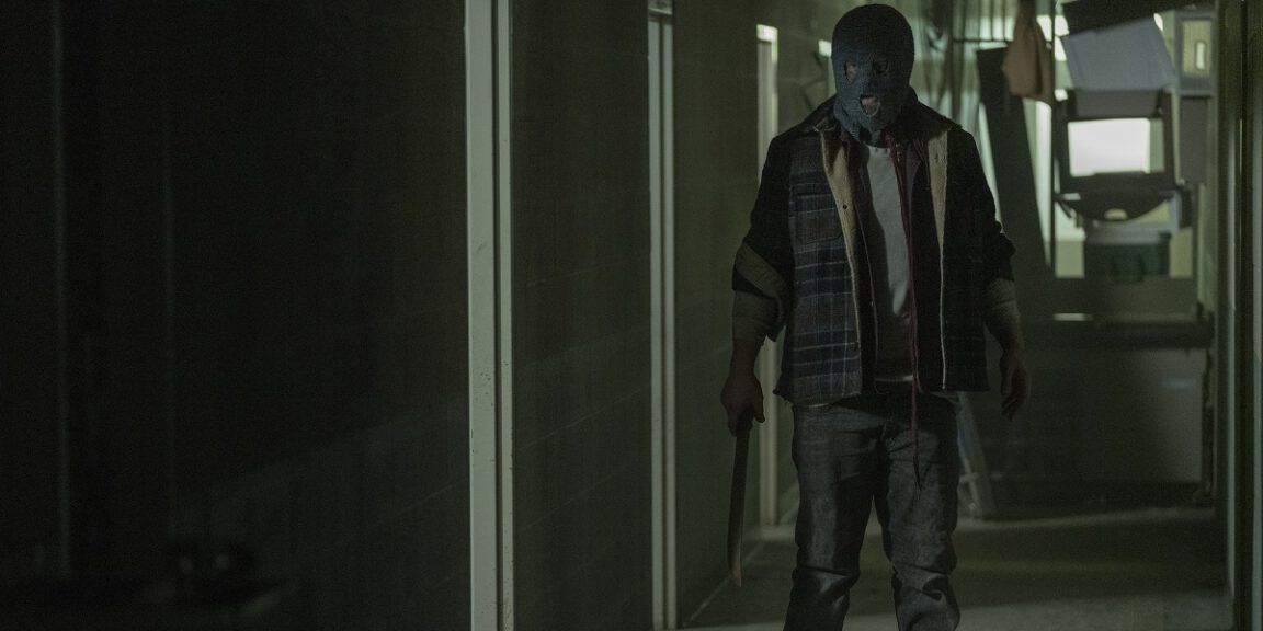 Beta stands in the hallway with a mask on in TWD