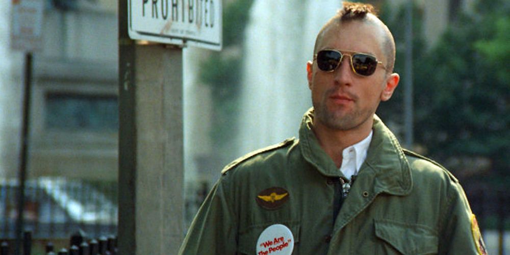 Travis Bickle stands outside with his new Mohawk haircut in Taxi Driver