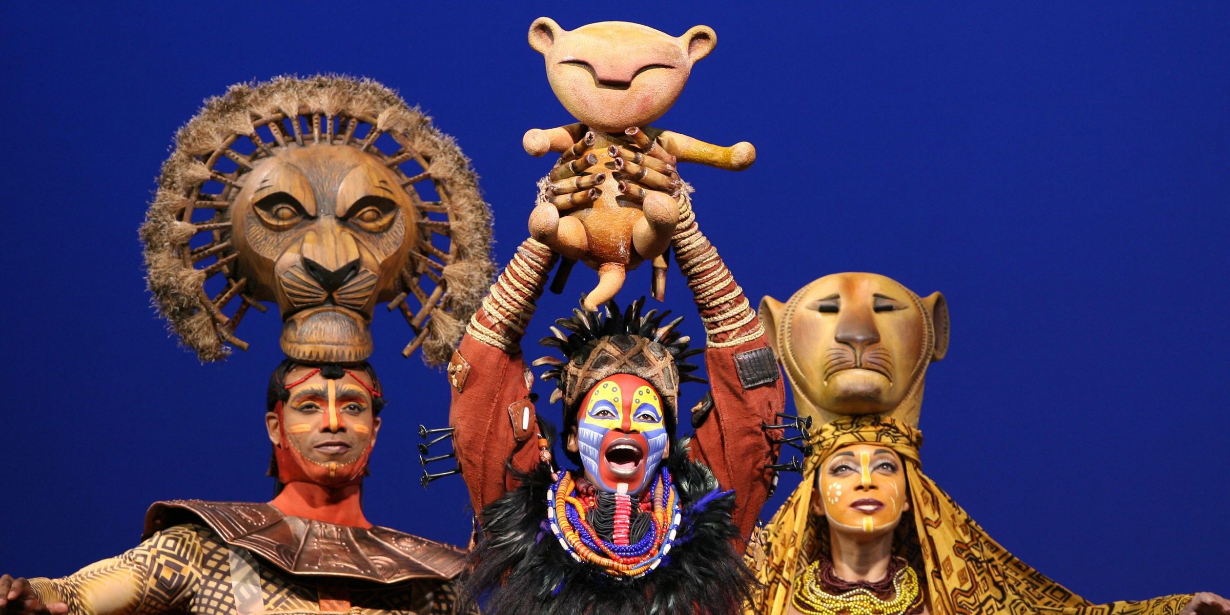 The Lion King musical on stage featuring a baby simba