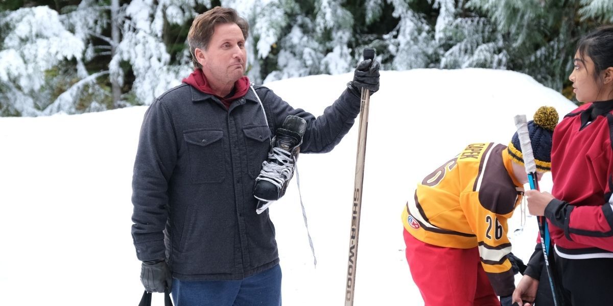 Coach Bombay on the pond ice with the team