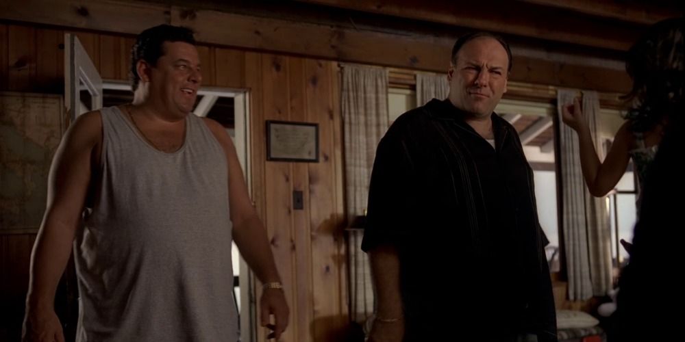 Tony Soprano and Bobby stand side by side looking down.