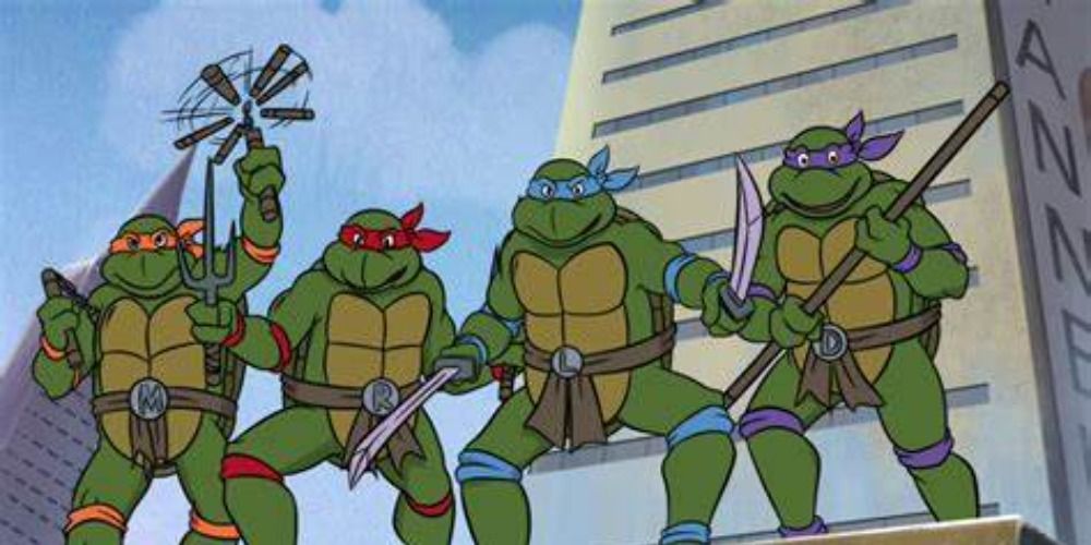 The Teenage Mutant Ninja Turtles on top of a roof wielding weapons