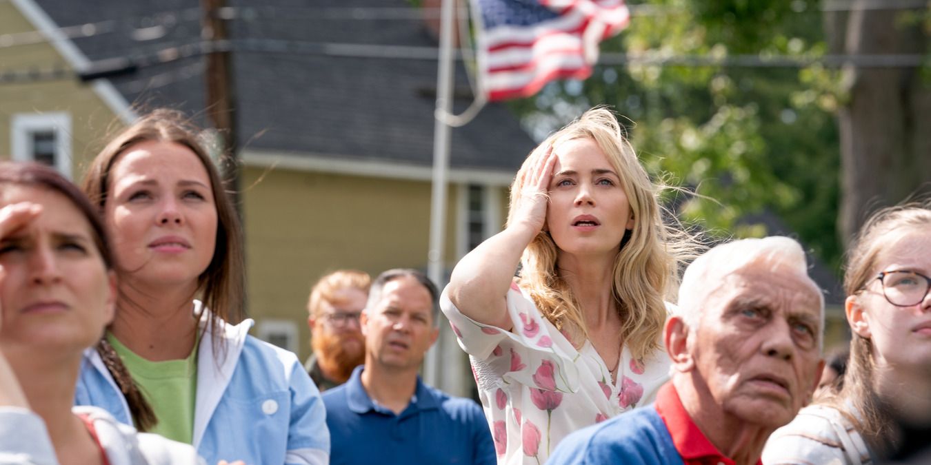 Emily Blunt and other characters look up from the bleachers in A Quiet Place 2