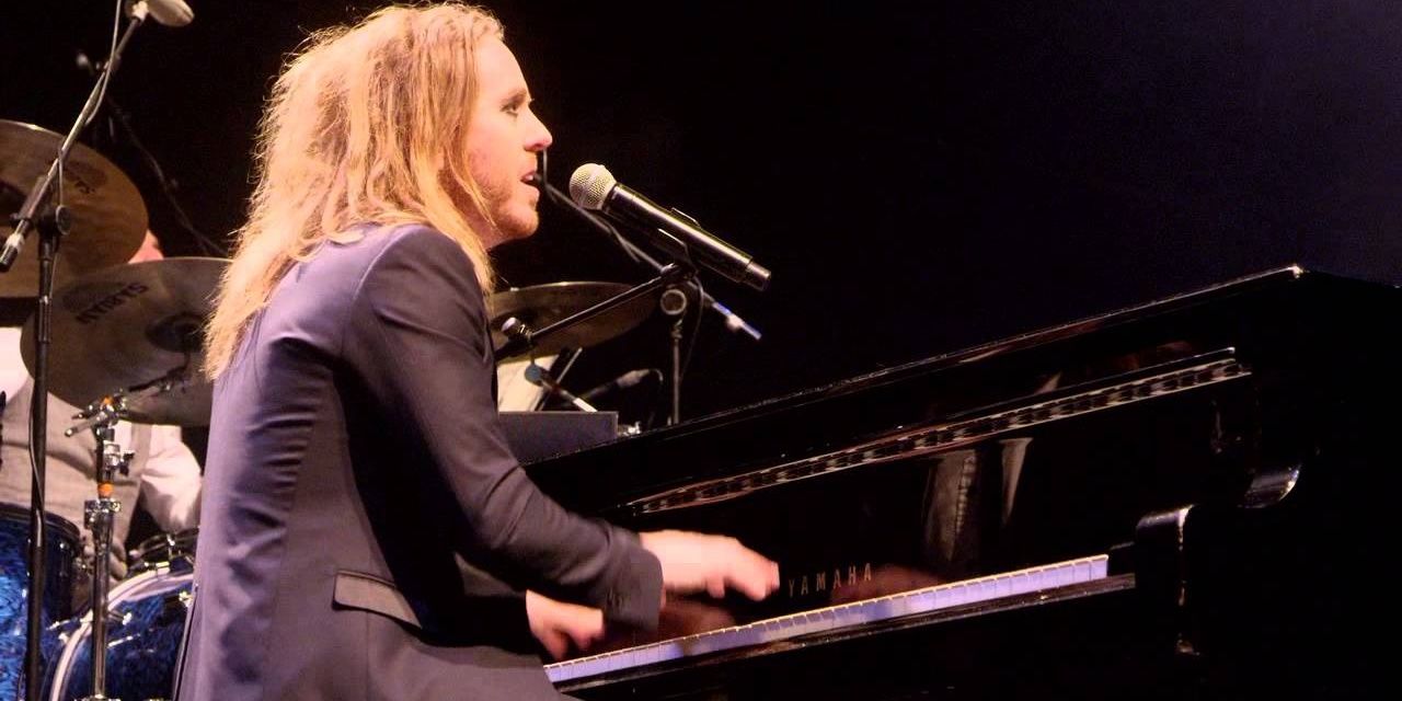 Tim Minchin playing the piano in his So F------ Rock Live concert