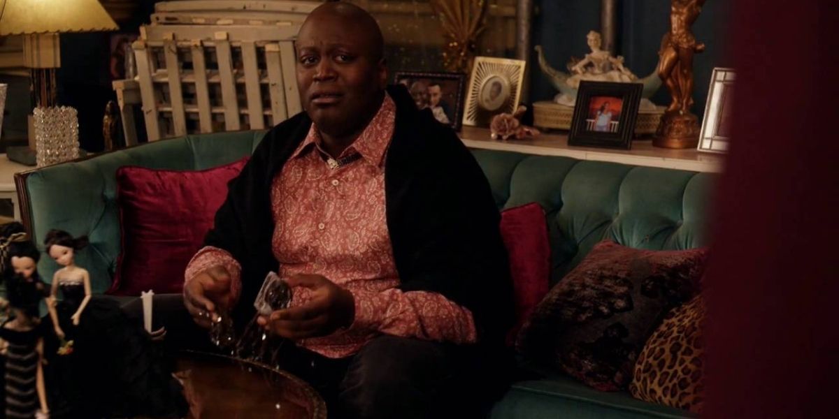 Titus sitting in the couch looking distressed in Unbreakable Kimmy Schmidt