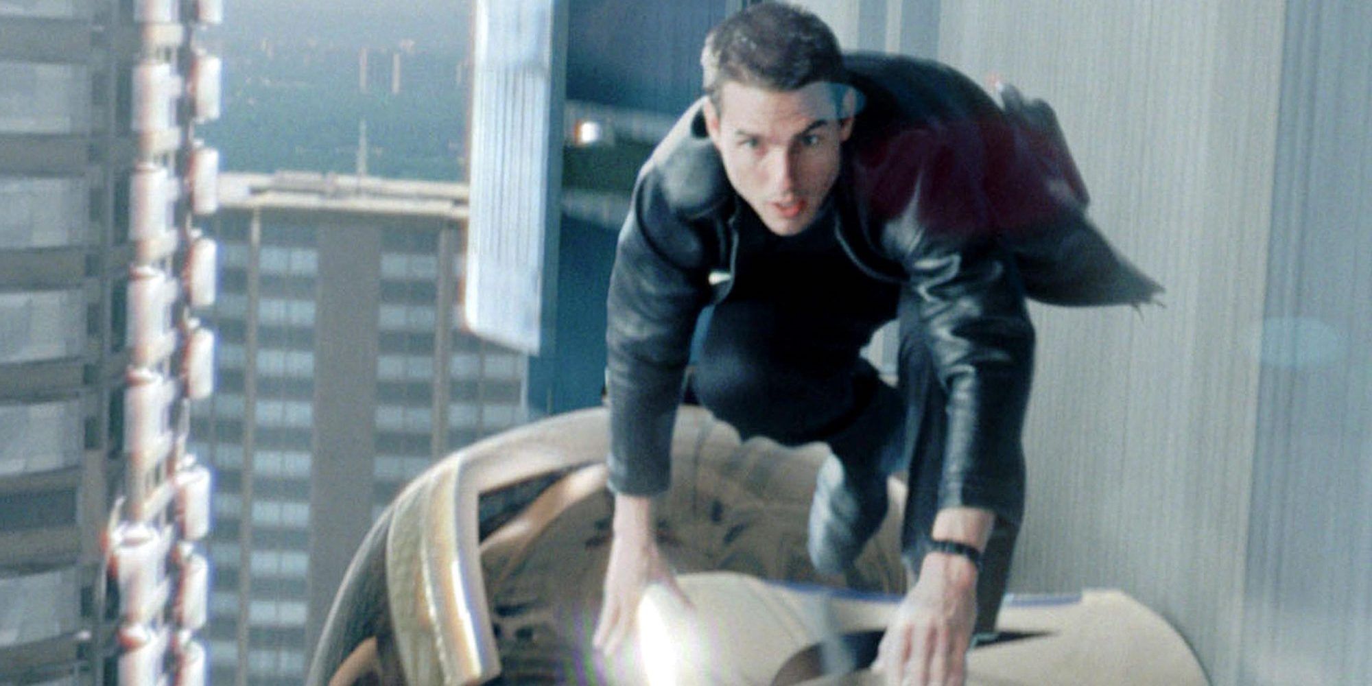 Tom Cruise balancing on top of a moving car pod in Minority Report (2002)