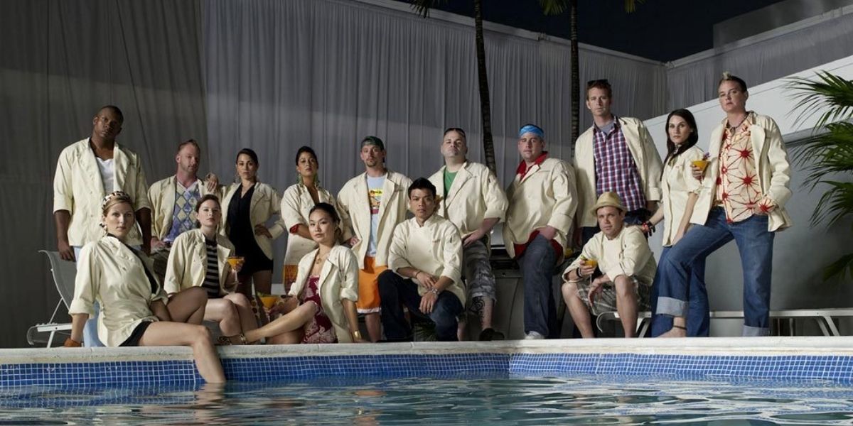 The cast of Top Chef Miami posing by a pool