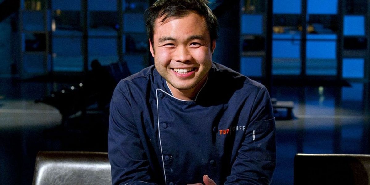 Paul Qui in the kitchen smiling for the camera