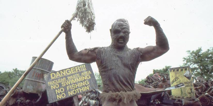 Toxic Avenger holding up his mop.