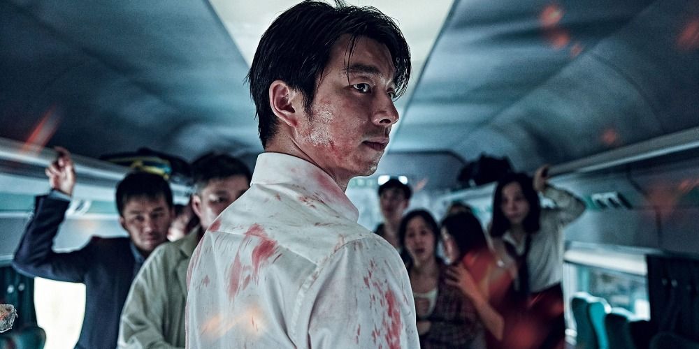 Seok-woo looking over his shoulder on a train in Train to Busan