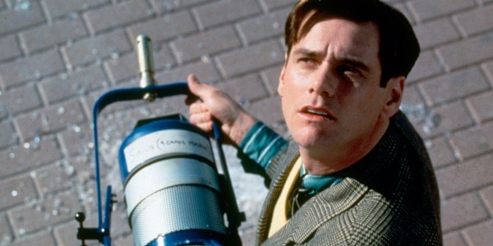 Truman picks up a light that fell from the sky in Truman Show